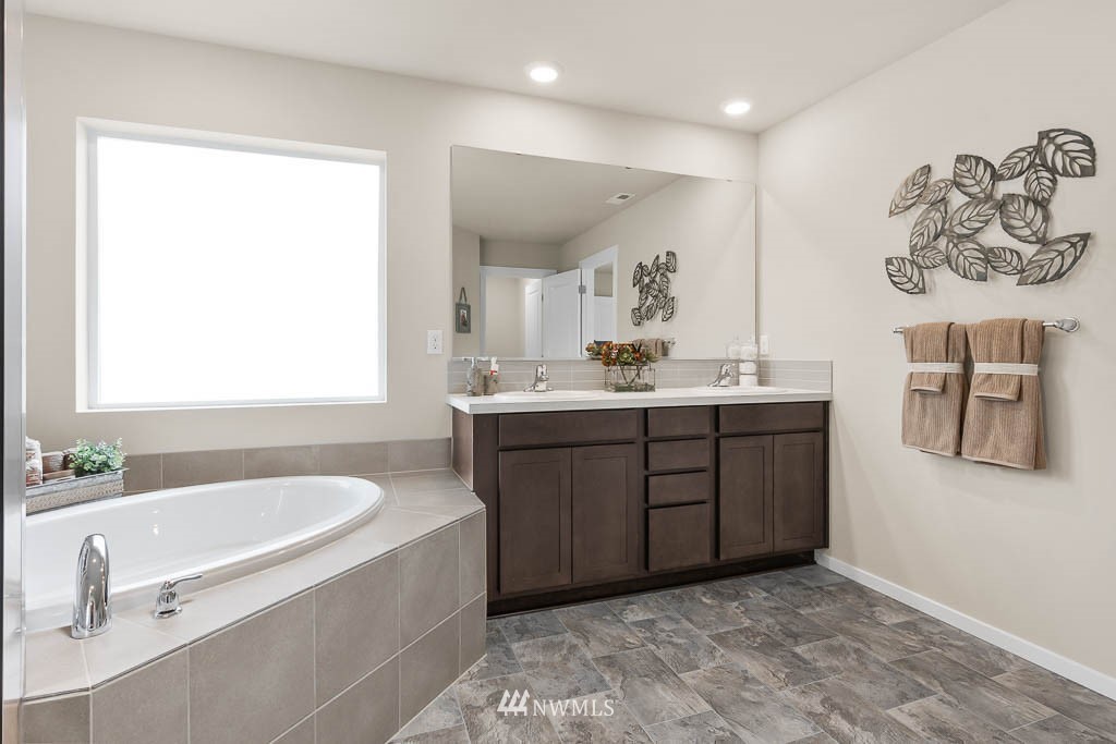 21119 Meridian Drive Southeast, Unit P21 Bothell, WA 98021 - Photo 23 of 31 a spacious bathroom with a tub sink and mirror
