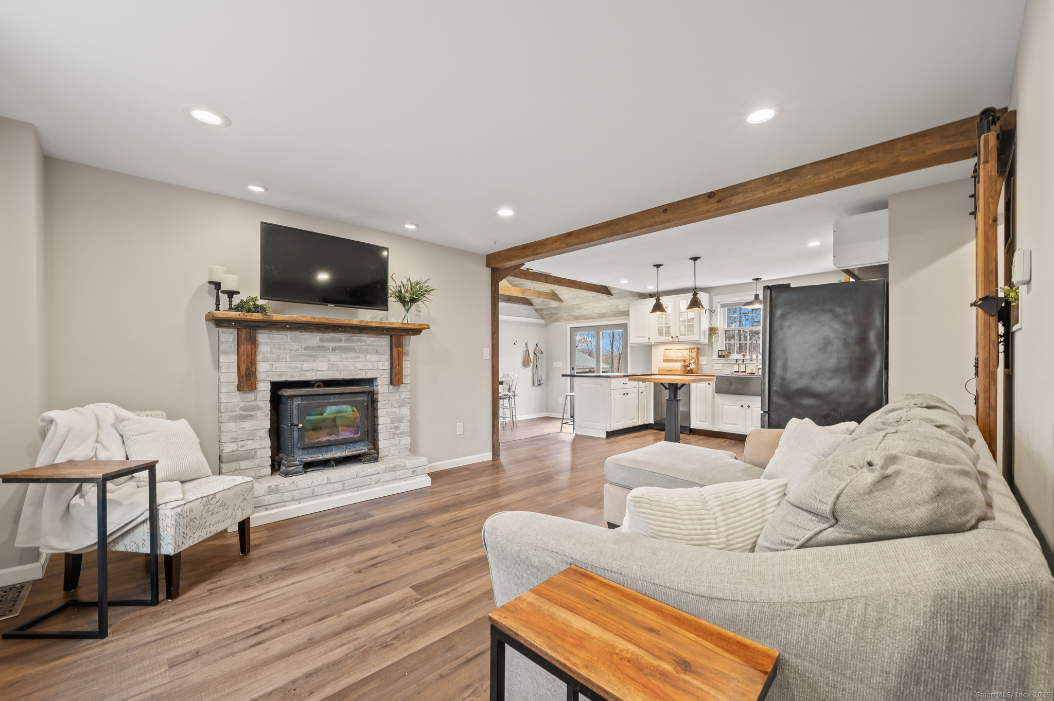 192 Leonard Road Stafford, CT 06076 - Photo 12 of 40 a living room with furniture a fireplace and a flat screen tv