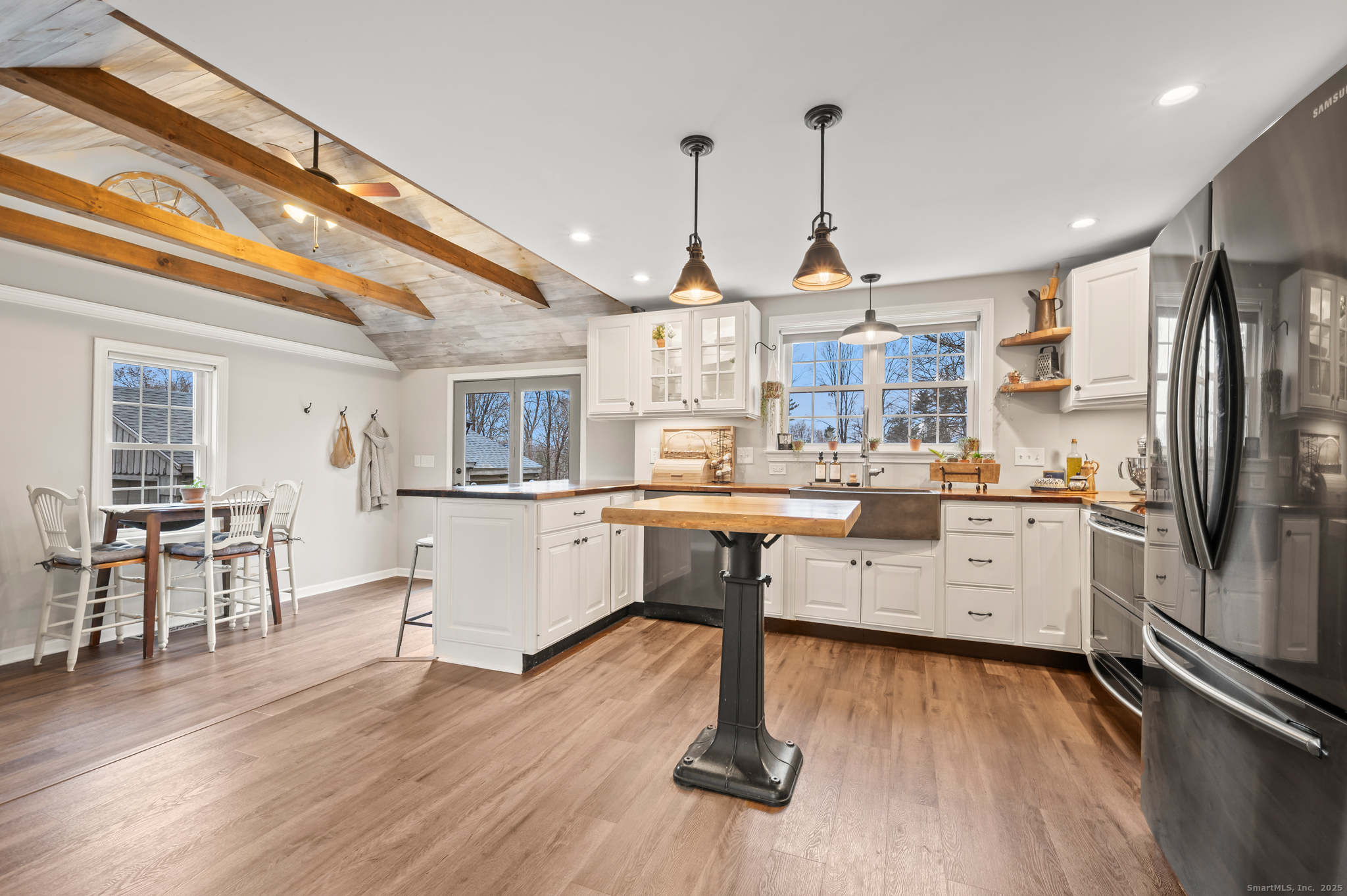 192 Leonard Road Stafford, CT 06076 - Photo 5 of 40 a kitchen with a refrigerator a sink dishwasher a dining table and chairs with wooden floor