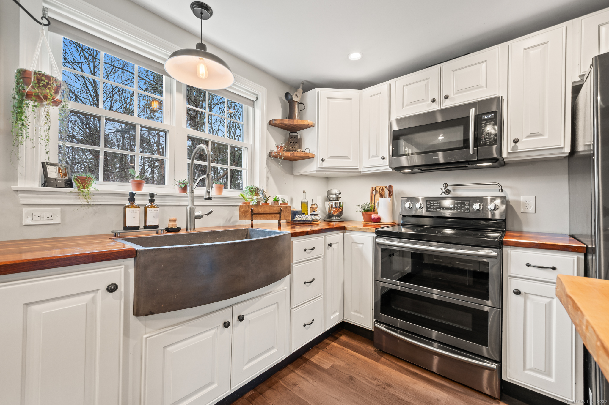 192 Leonard Road Stafford, CT 06076 - Photo 7 of 40 a kitchen with stainless steel appliances a stove microwave and sink