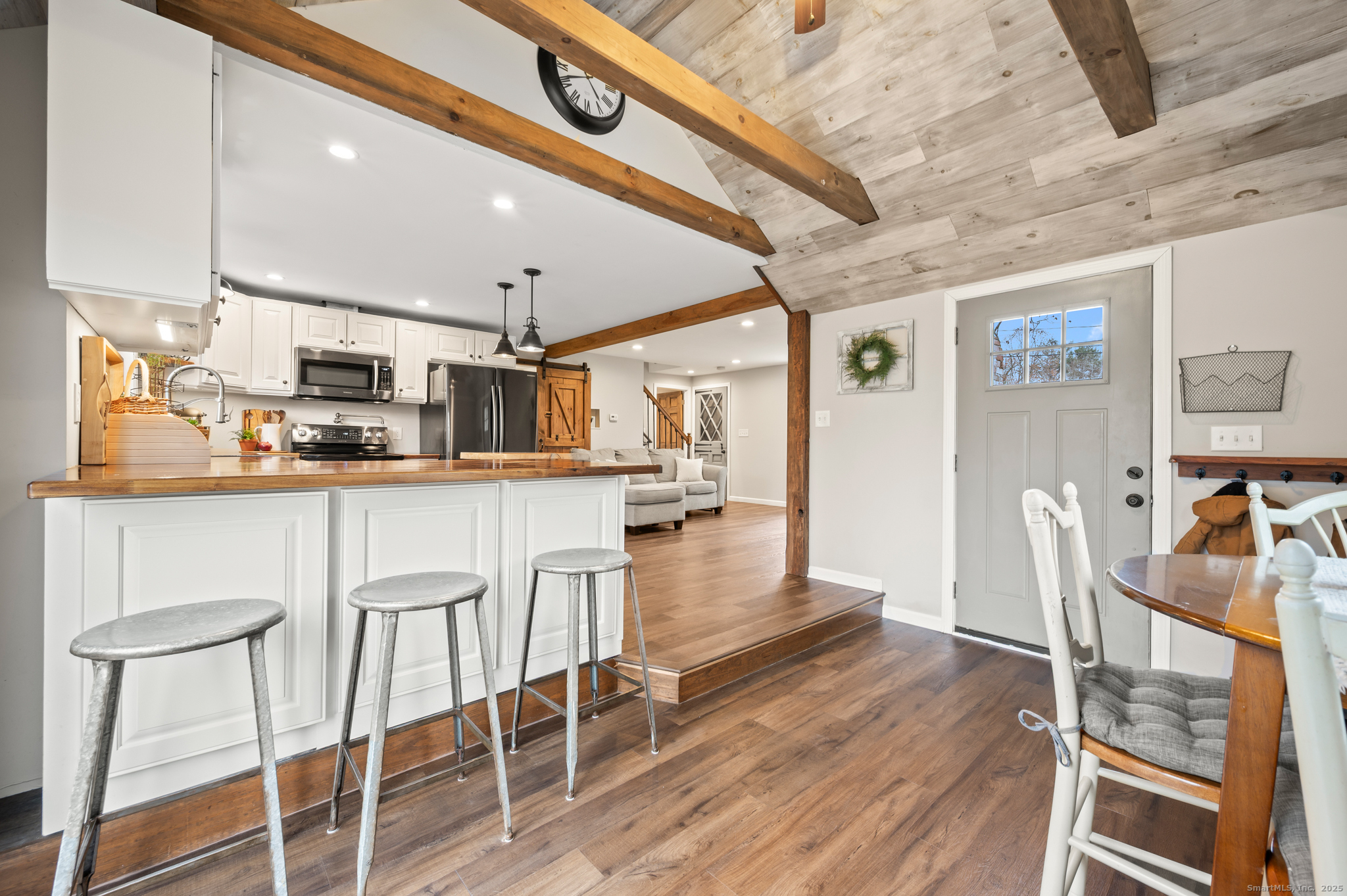 192 Leonard Road Stafford, CT 06076 - Photo 8 of 40 a kitchen with stainless steel appliances kitchen island granite countertop a table chairs in it and wooden floors