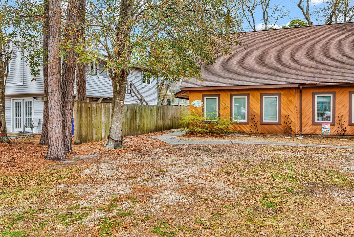 Back of property featuring a shingled roof