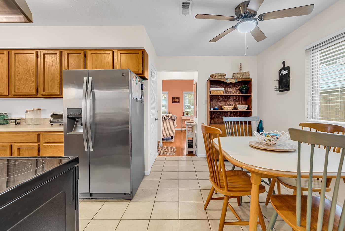 724 Juniper Drive, Unit B Surfside Beach, SC 29575 - Photo 13 of 36 Kitchen featuring brown cabinetry, stainless steel refrigerator with ice dispenser, light tile patterned flooring, and healthy amount of natural light