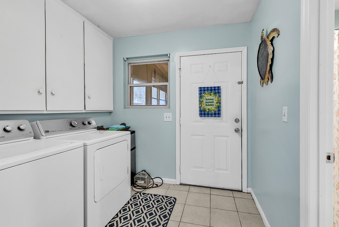 724 Juniper Drive, Unit B Surfside Beach, SC 29575 - Photo 14 of 36 Washroom featuring light tile patterned flooring, washer and dryer, and cabinet space
