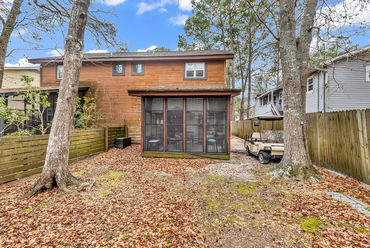 724 Juniper Drive, Unit B Surfside Beach, SC 29575 - Photo 29 of 36 Back of house featuring a fenced backyard and a sunroom