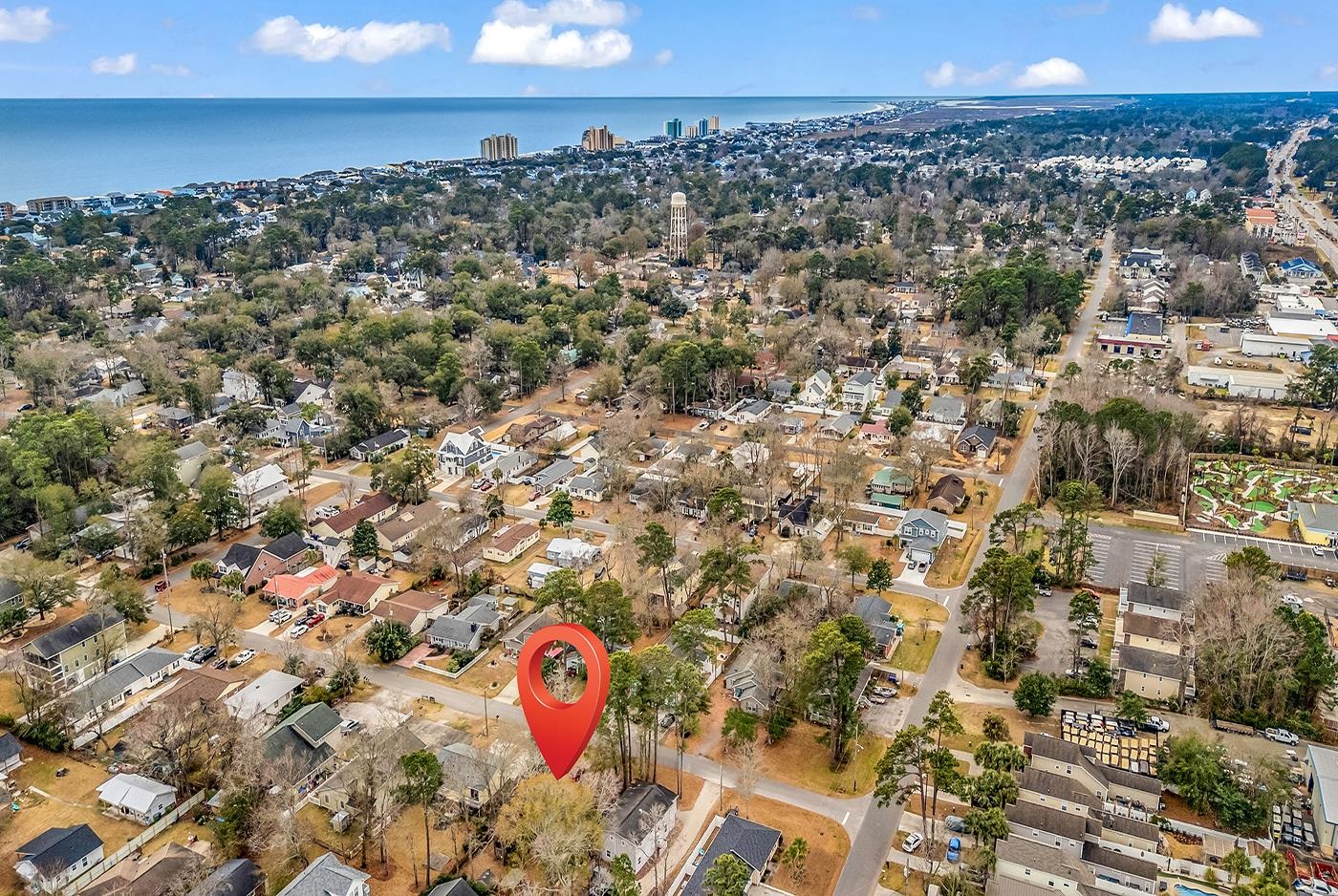 724 Juniper Drive, Unit B Surfside Beach, SC 29575 - Photo 35 of 36 Aerial view of property's location featuring nearby suburban area and a nearby body of water