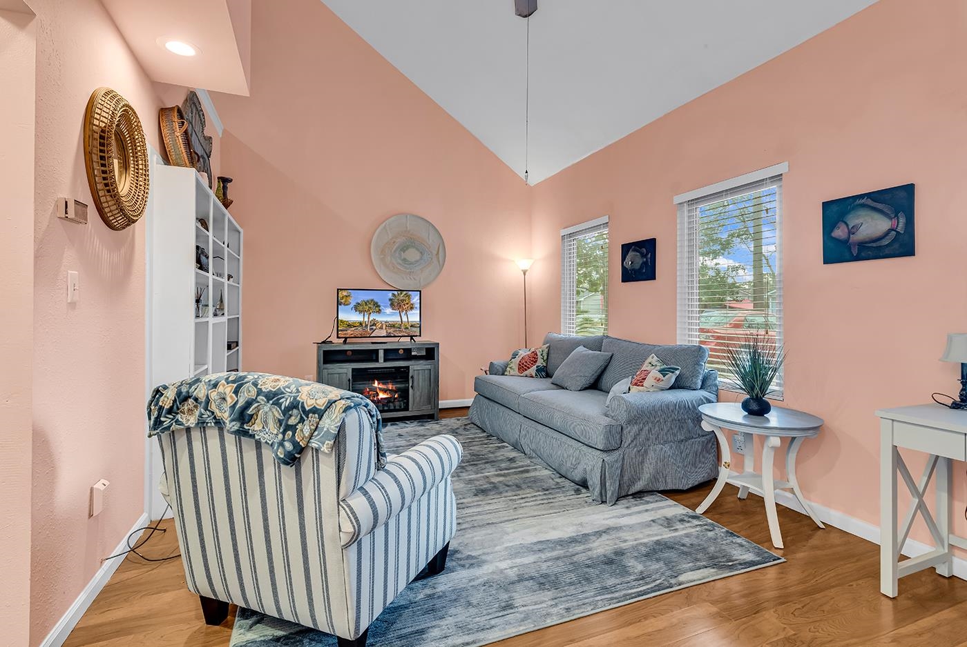 724 Juniper Drive, Unit B Surfside Beach, SC 29575 - Photo 4 of 36 Living area with wood finished floors, a warm lit fireplace, and high vaulted ceiling