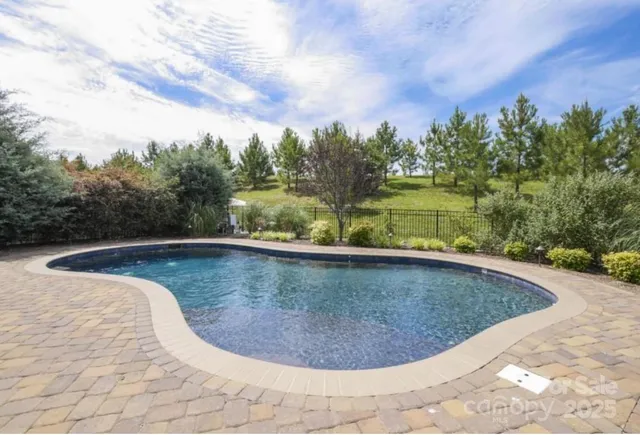 a view of a house with swimming pool and sitting area