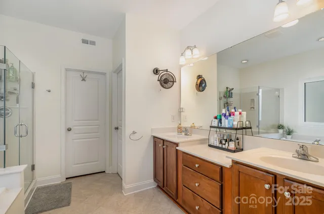 a spacious bathroom with a tub sink and mirror