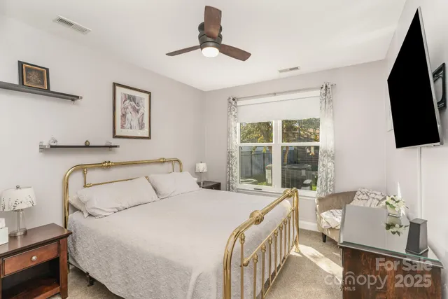 a bathroom with a granite countertop sink a toilet a mirror and shower
