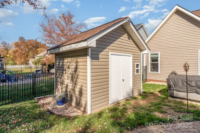 a backyard of a house with table and chairs
