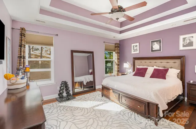 a view of a white house next to a yard and trees