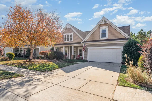 a living room with furniture a chandelier and a rug