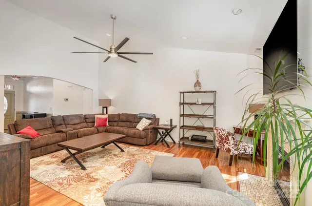 a living room with fireplace furniture and a flat screen tv