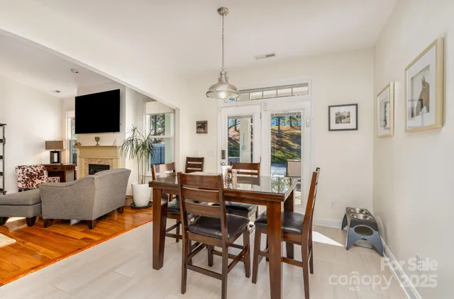 a kitchen with stainless steel appliances granite countertop a stove top oven a sink a refrigerator and white cabinets