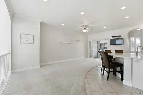 an empty room with chandelier fan