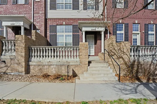 front view of a brick house with large windows