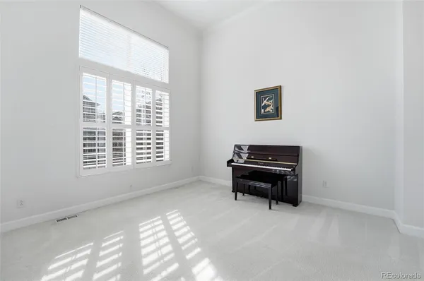a room with a window and a piano
