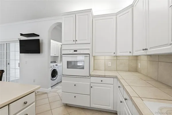 a kitchen with stainless steel appliances white cabinets and a sink