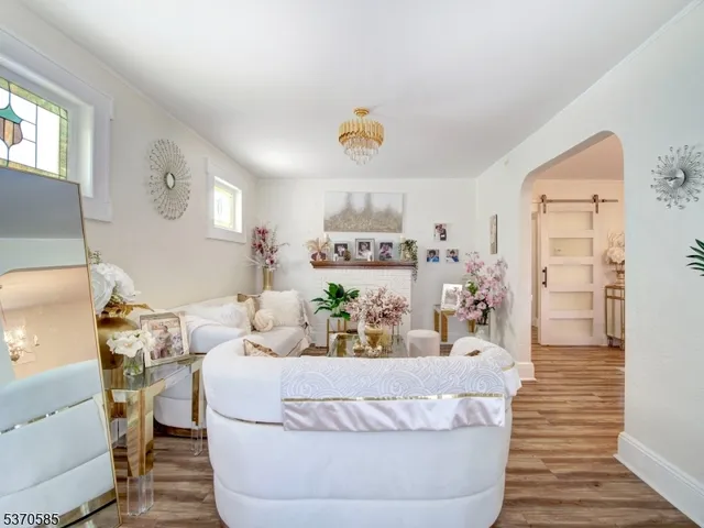 a living room with furniture and painting on the wall