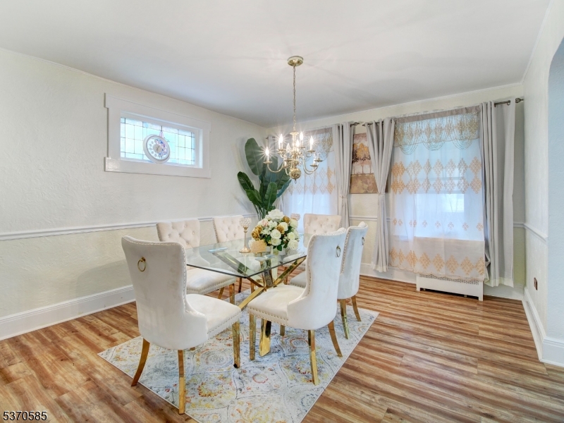 73 South Maple Avenue Springfield, NJ 07081 - Photo 12 of 26 a view of a dining room with furniture wooden floor and a chandelier