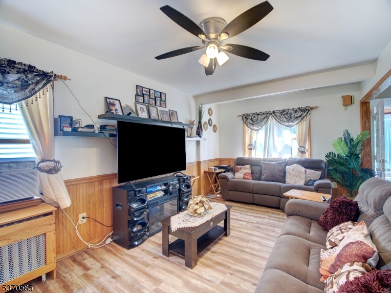 73 South Maple Avenue Springfield, NJ 07081 - Photo 14 of 26 a living room with furniture and a flat screen tv