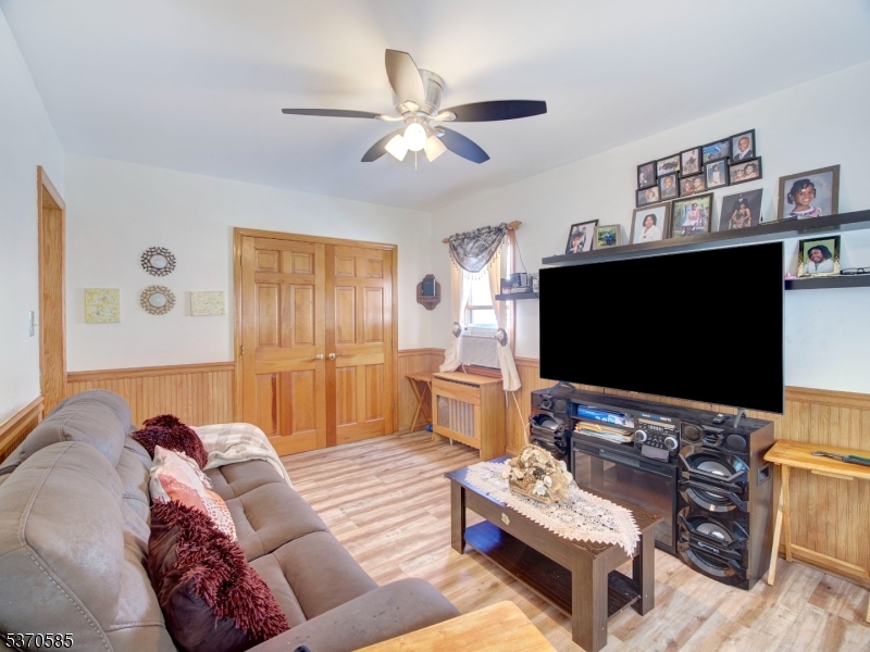 73 South Maple Avenue Springfield, NJ 07081 - Photo 15 of 26 a living room with furniture and a flat screen tv