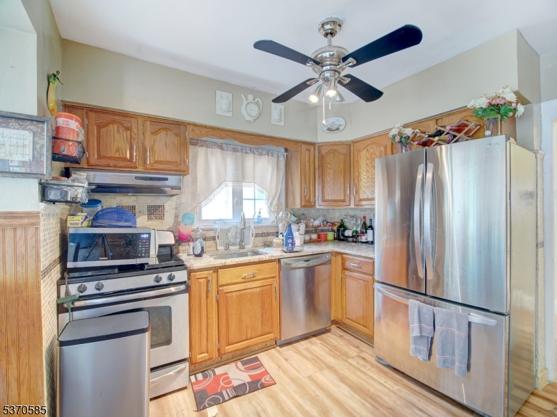 73 South Maple Avenue Springfield, NJ 07081 - Photo 16 of 26 a kitchen with stainless steel appliances a stove a refrigerator and a sink