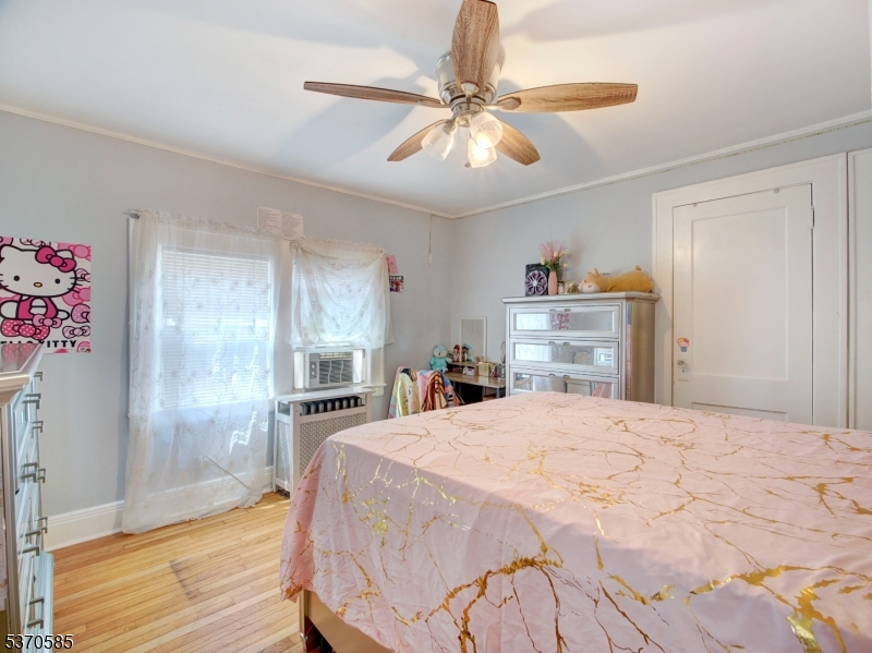 73 South Maple Avenue Springfield, NJ 07081 - Photo 20 of 26 a bedroom with a bed and a chandelier