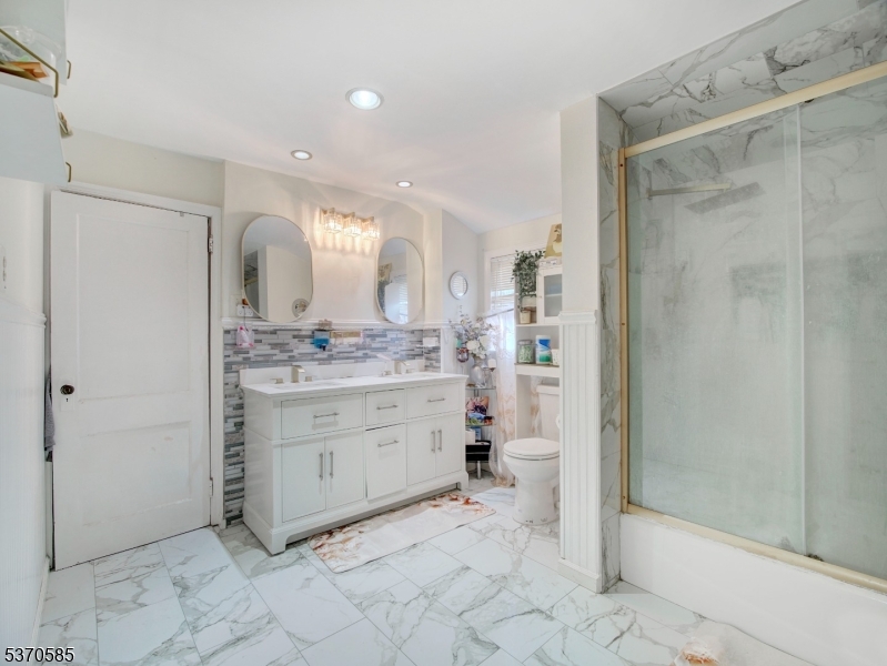73 South Maple Avenue Springfield, NJ 07081 - Photo 22 of 26 a bathroom with a sink and a mirror