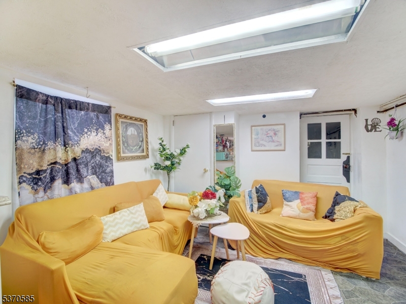 73 South Maple Avenue Springfield, NJ 07081 - Photo 23 of 26 a living room with furniture and wooden floor