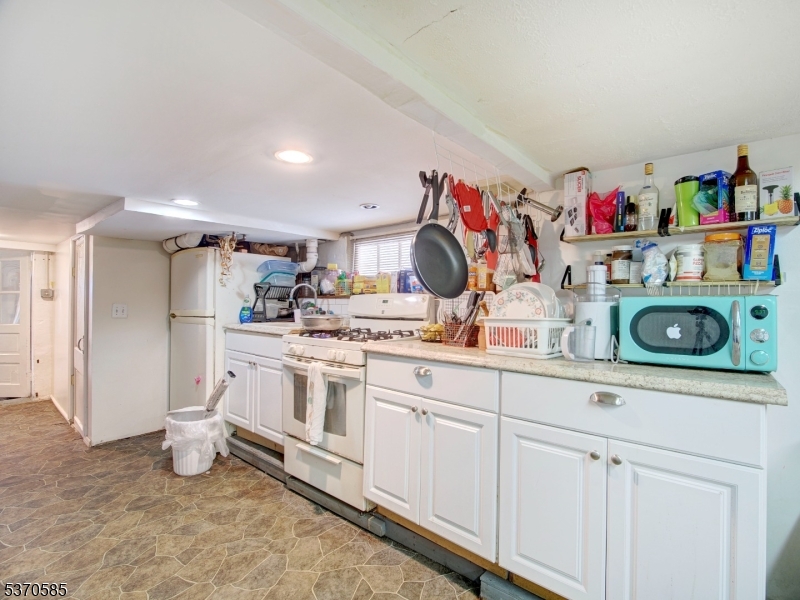 73 South Maple Avenue Springfield, NJ 07081 - Photo 24 of 26 a kitchen with white cabinets and white appliances