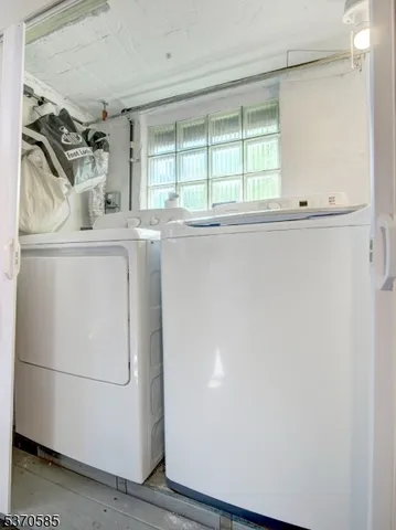 a bathroom with a window and a shower