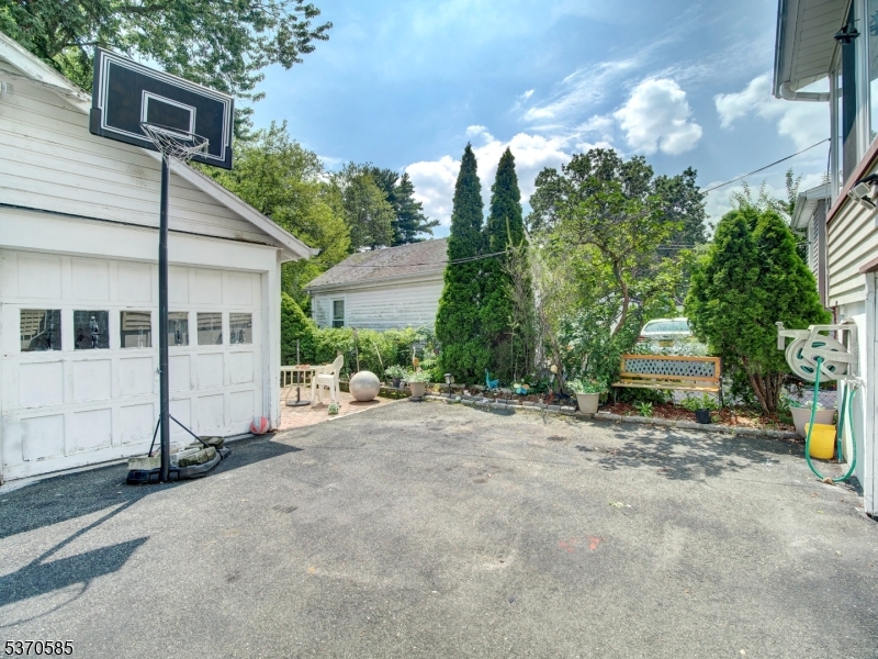 73 South Maple Avenue Springfield, NJ 07081 - Photo 5 of 26 a view of a house with a patio and a yard