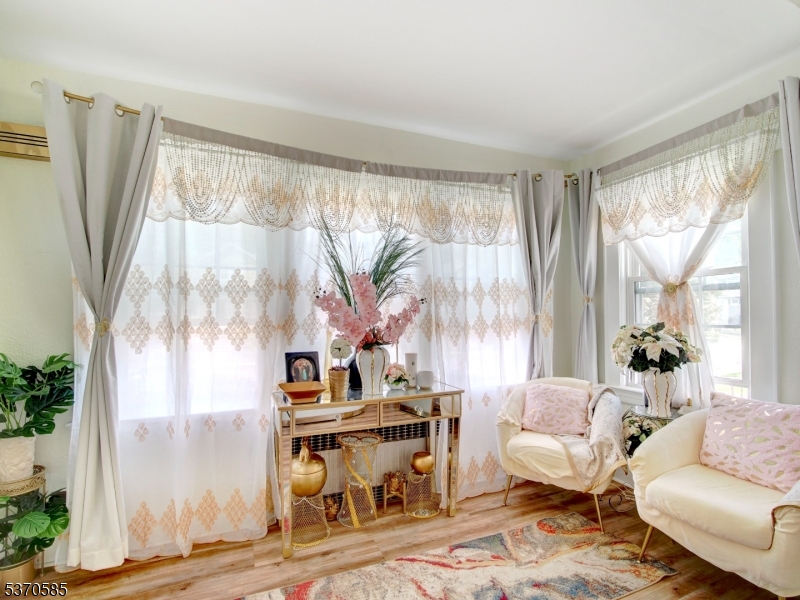 73 South Maple Avenue Springfield, NJ 07081 - Photo 10 of 26 a living room with furniture and a large window