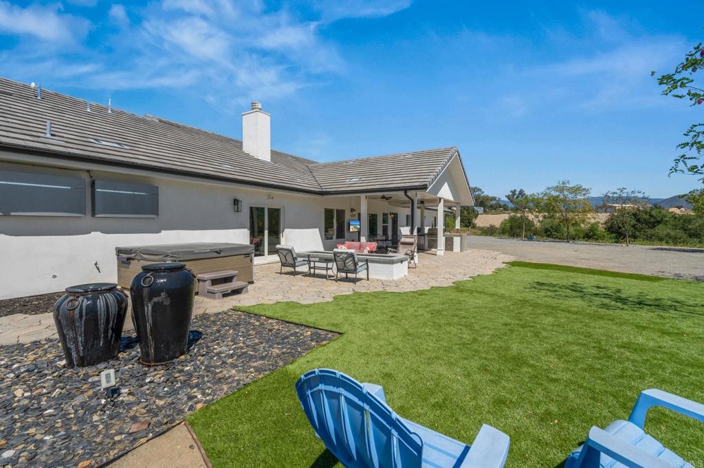 15663 Mathew Road Valley Center, CA 92082 - Photo 40 of 55 a view of a patio with table and chairs potted plants with wooden fence