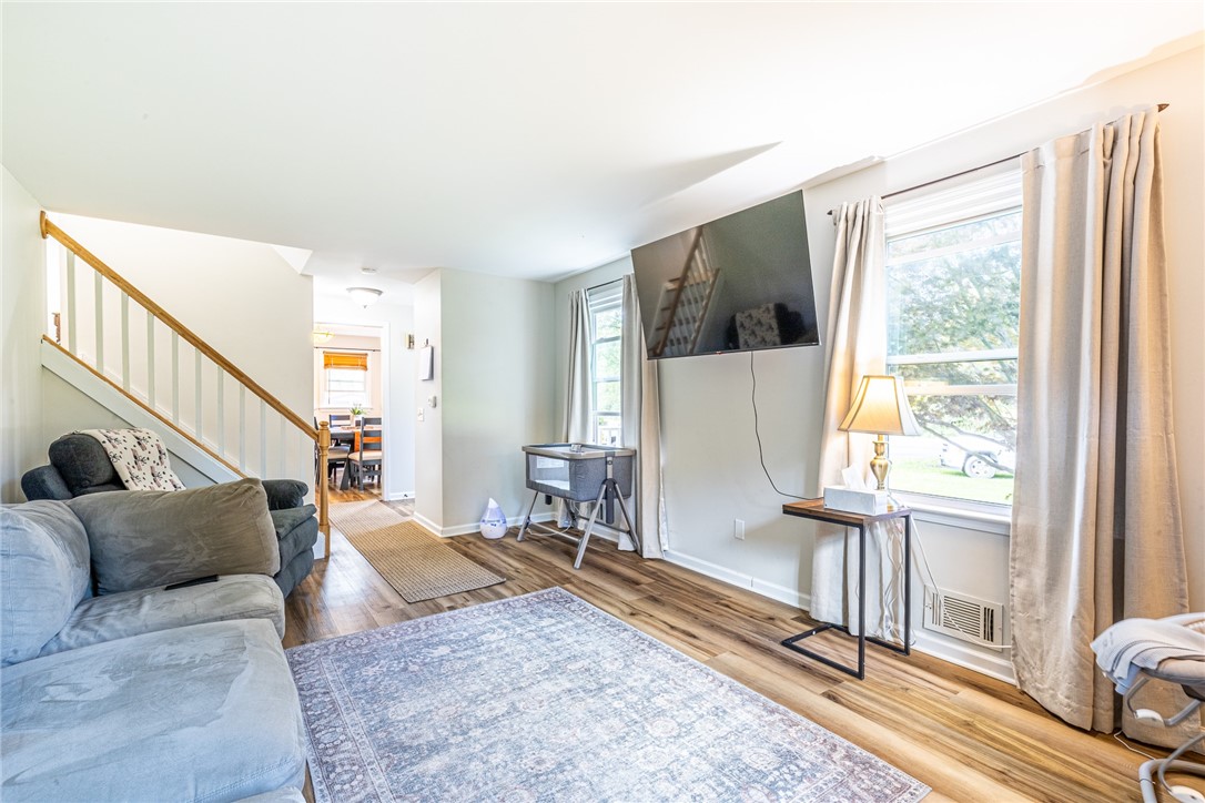 6432 Lakeside Road Ontario, NY 14519 - Photo 8 of 35 Warm wood-toned floors and abundant natural light create a welcoming living room atmosphere.