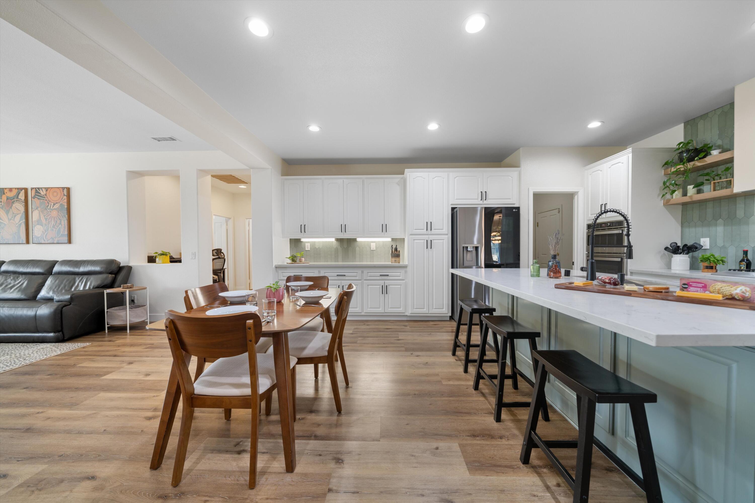 19475 Spalding Avenue Riverside, CA 92508 - Photo 14 of 50 a kitchen with stainless steel appliances kitchen island granite countertop a table chairs sink and cabinets