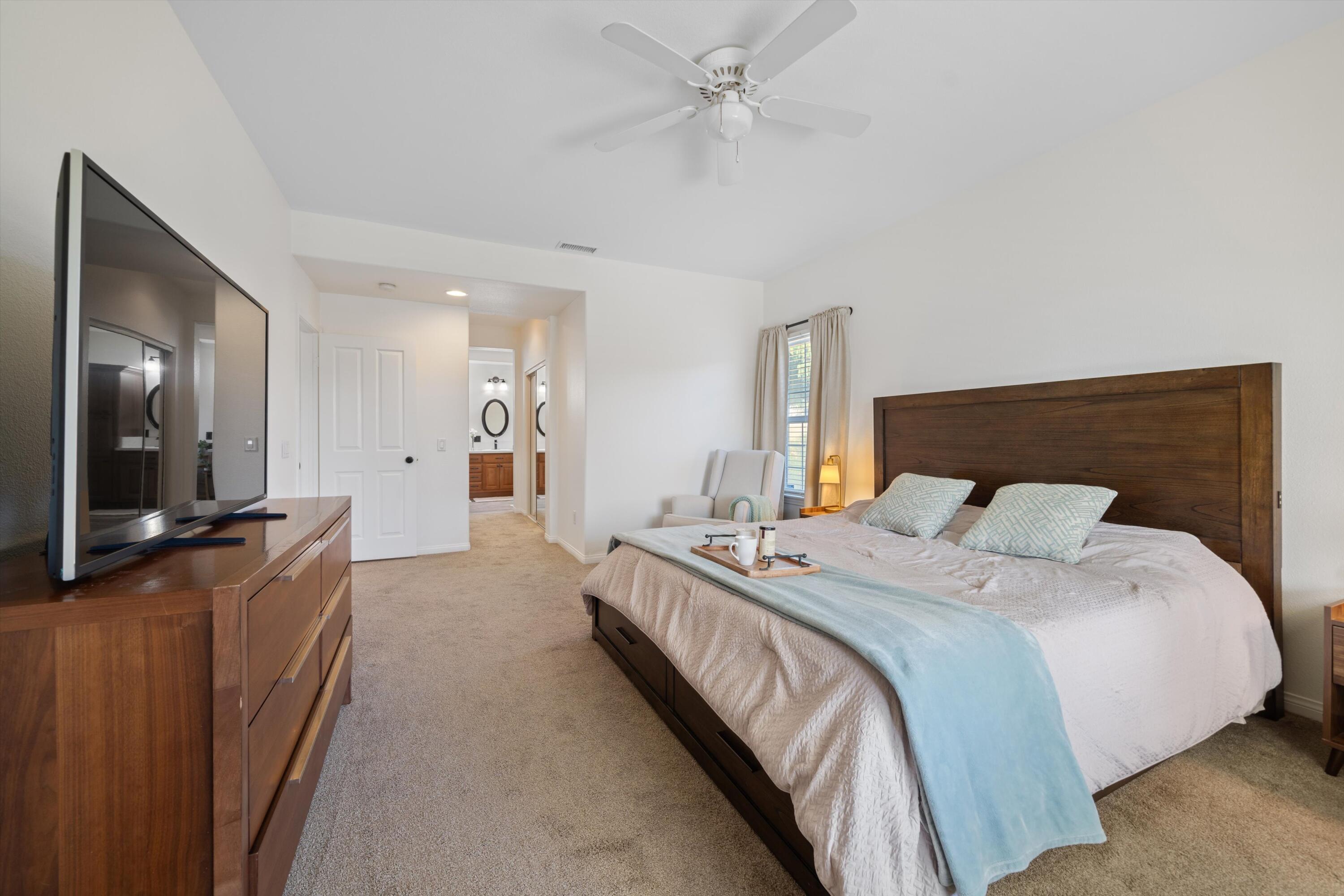 19475 Spalding Avenue Riverside, CA 92508 - Photo 19 of 50 a spacious bedroom with a bed and a flat screen tv