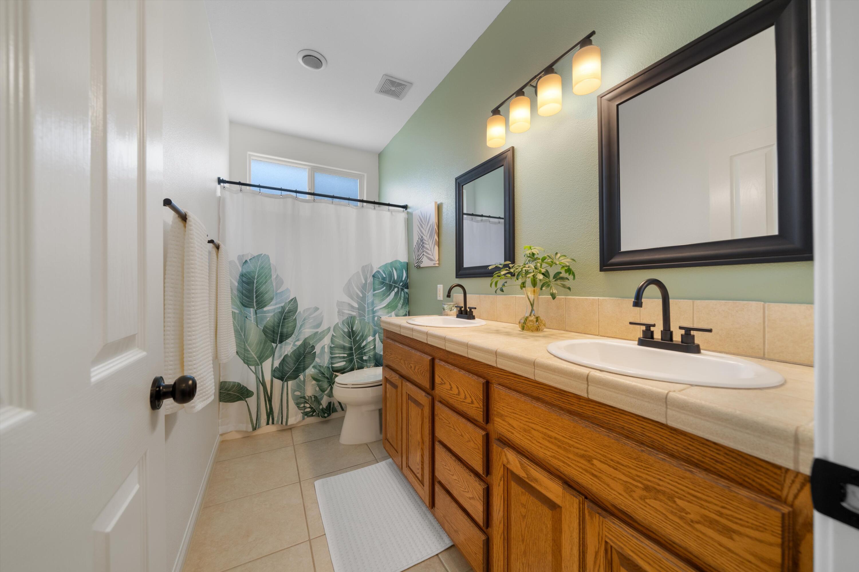 19475 Spalding Avenue Riverside, CA 92508 - Photo 22 of 50 a spacious bathroom with a double vanity sink a mirror and a shower