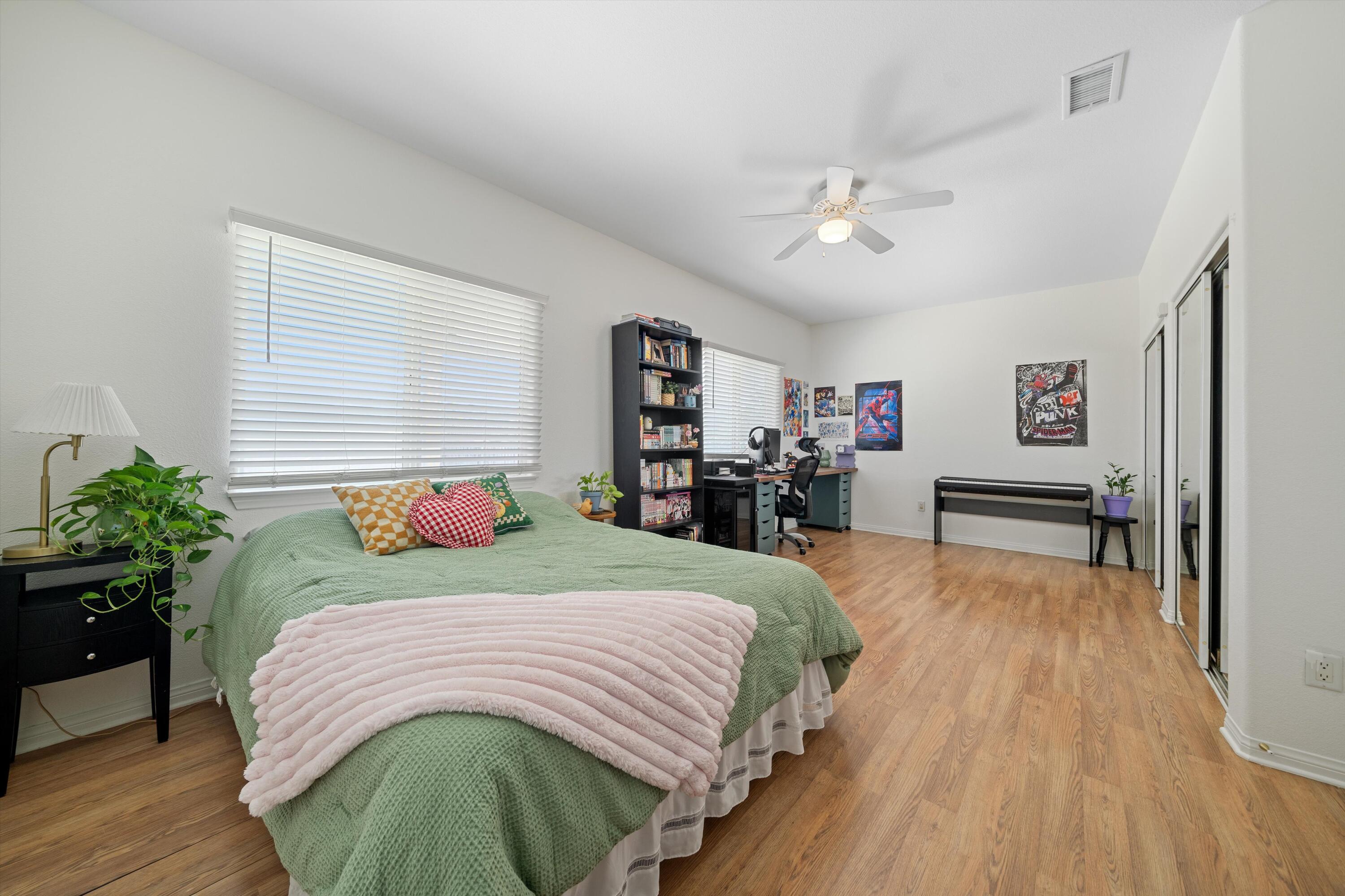 19475 Spalding Avenue Riverside, CA 92508 - Photo 23 of 50 a bedroom with a large bed and a wooden floor