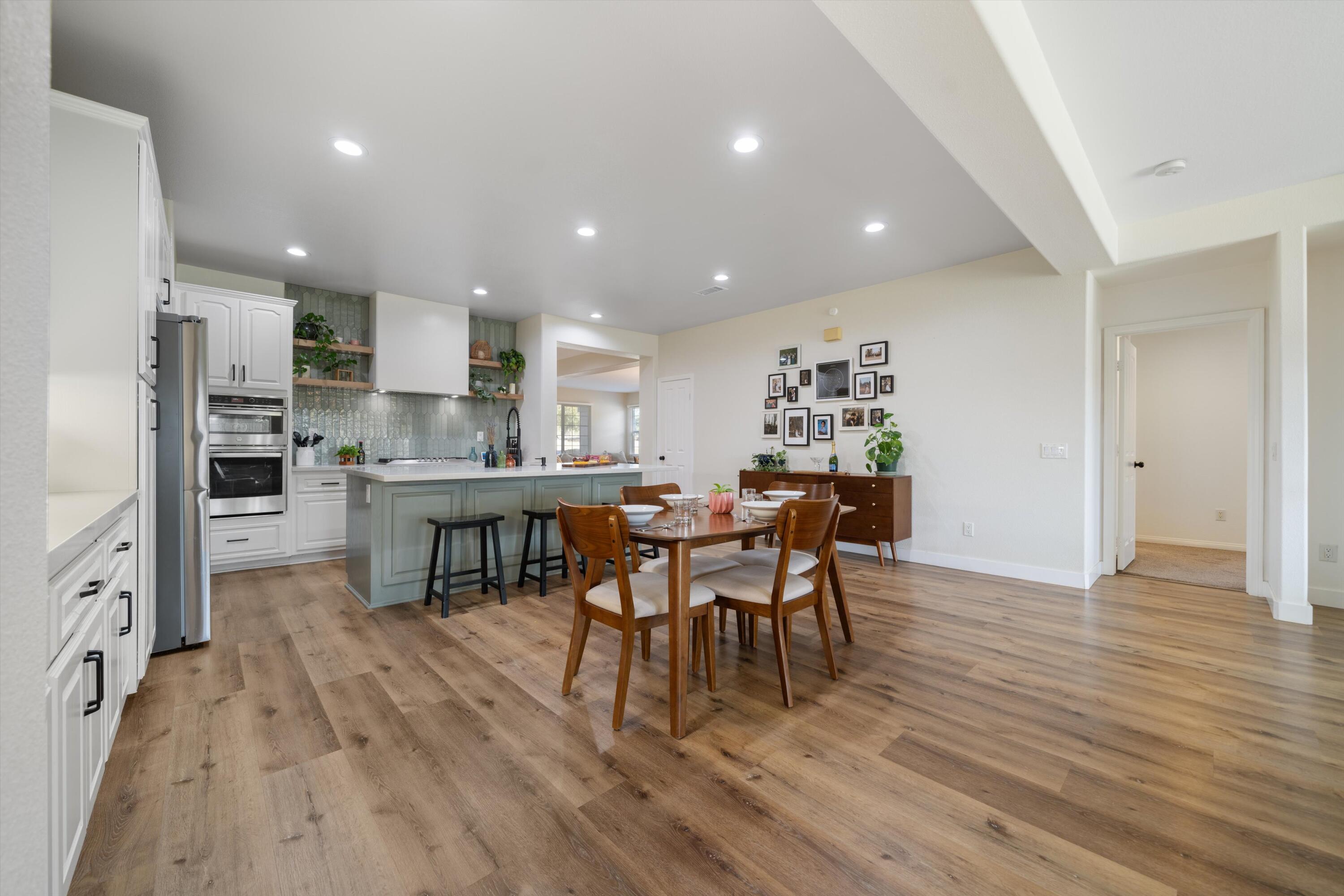 19475 Spalding Avenue Riverside, CA 92508 - Photo 9 of 50 a view of a dining room with furniture and wooden floor