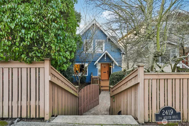 a front view of a house with wooden fence