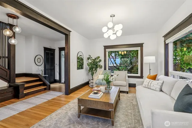 a living room with furniture a rug and a window