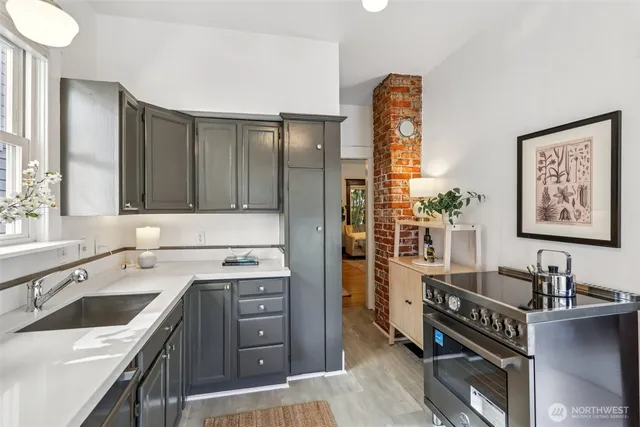 a kitchen with a sink stove and cabinets