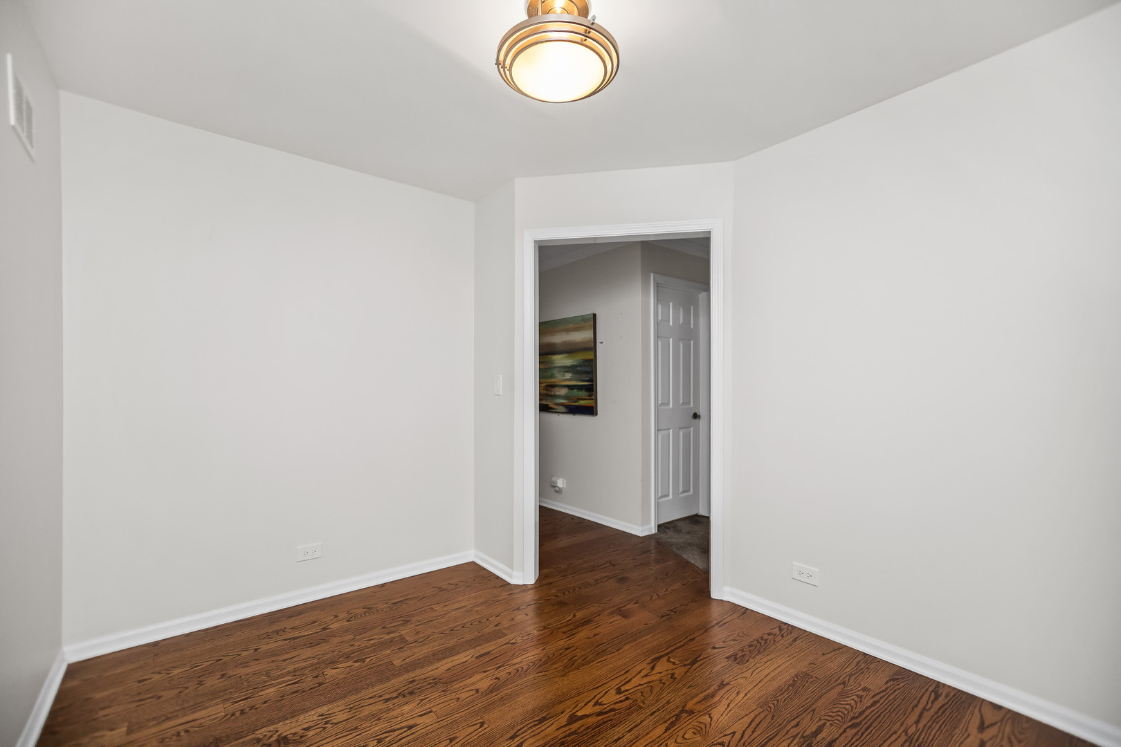 15 Landmark Street Northfield, IL 60093 - Photo 12 of 24 an empty room with wooden floor and windows
