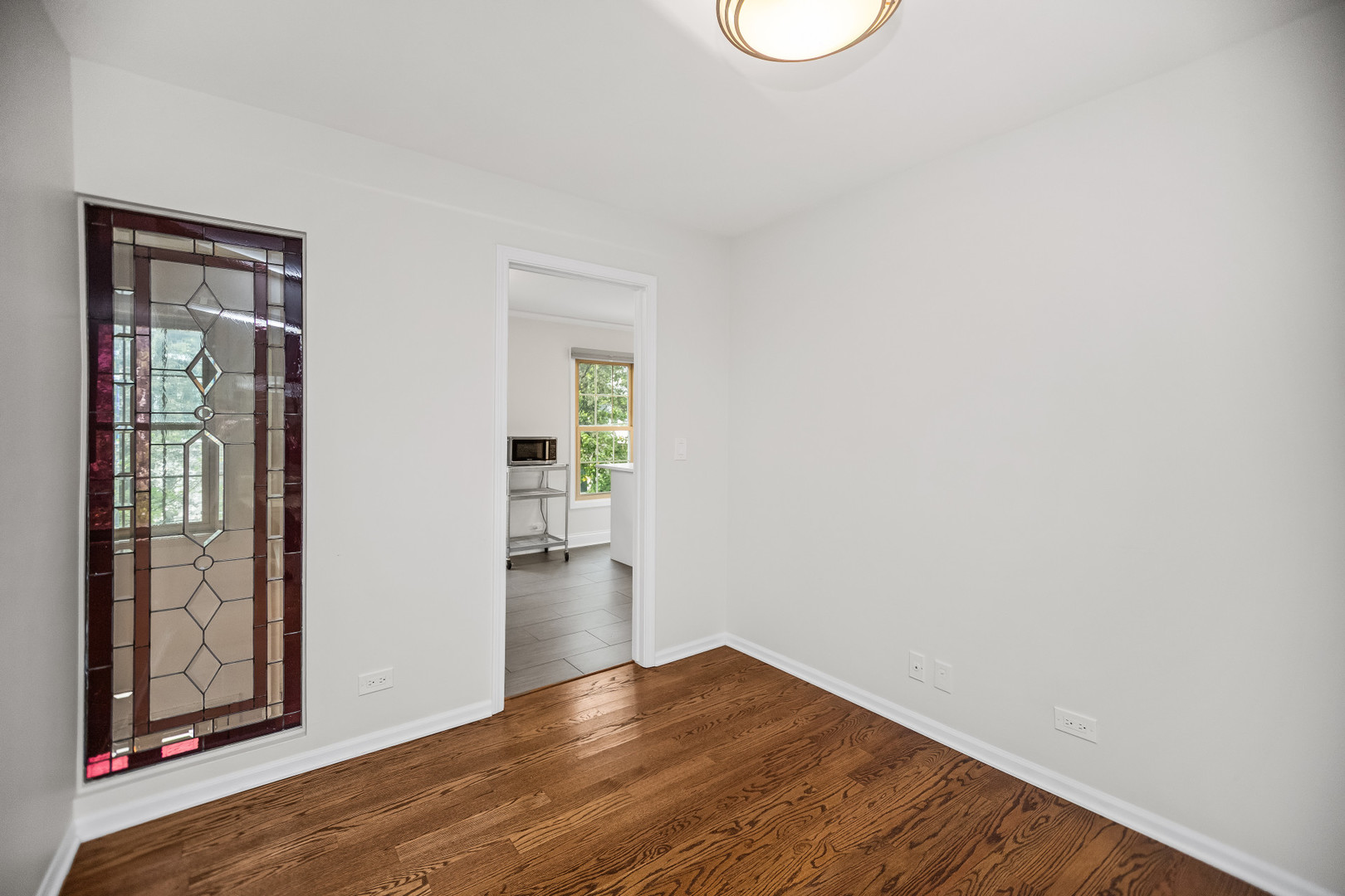 15 Landmark Street Northfield, IL 60093 - Photo 13 of 24 a view of an empty room with wooden floor and a window