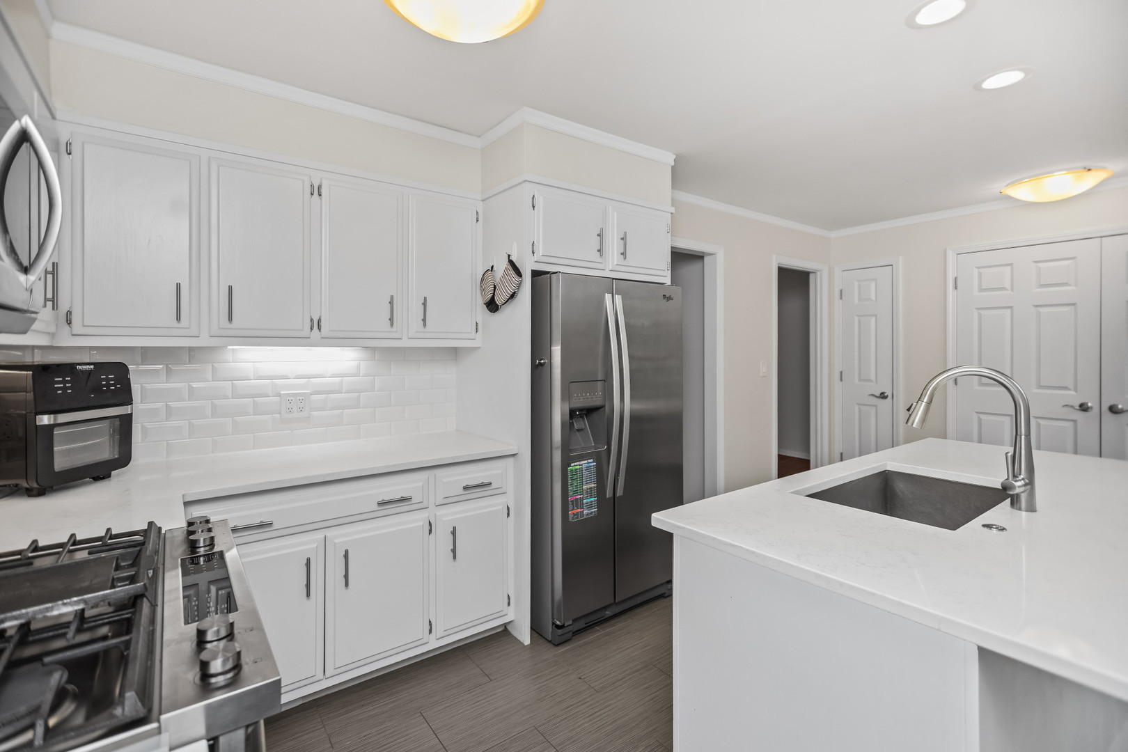 15 Landmark Street Northfield, IL 60093 - Photo 9 of 24 a kitchen with stainless steel appliances a refrigerator sink and cabinets