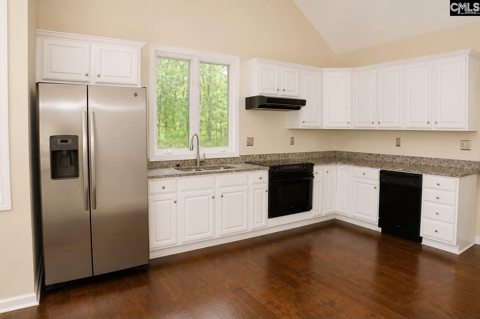 111 Lakeview Road Eastover, SC 29044 - Photo 16 of 39 a kitchen with a refrigerator sink and cabinets