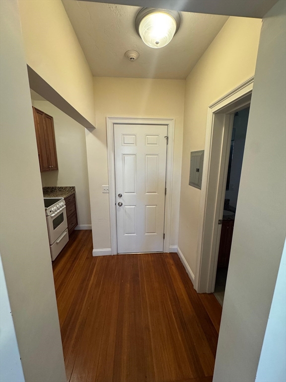 293 Broadway, Unit 2R Methuen, MA 01844 - Photo 2 of 6 a view of a hallway with wooden floor and a bathroom